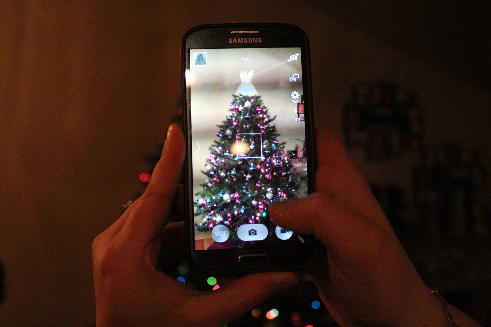 A resident documenting holiday decor, highlighting the need for disciplined On-site Security to prevent seasonal theft during the holidays