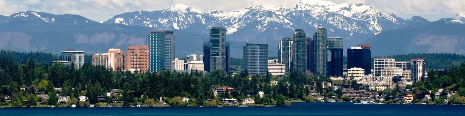 An aerial view over Lake Washington looking toward the Downtown Bellevue skyline, representing a key service area for Diligence Security On-site Security Officers and Patrol Services.