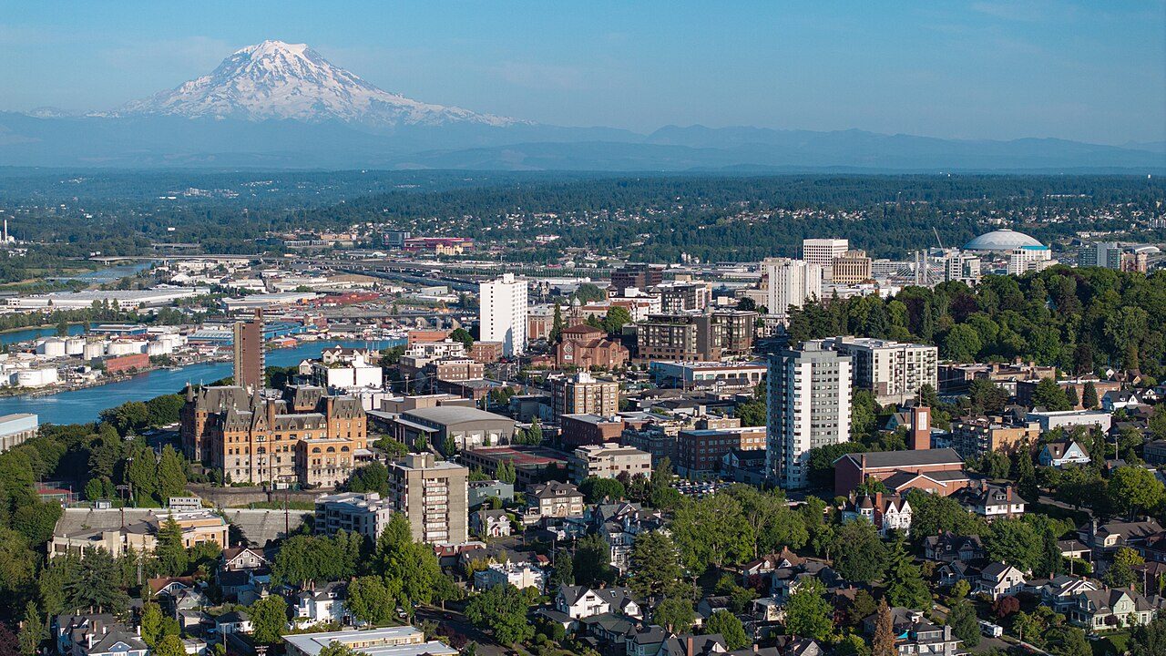Aerial view looking north into the City of Tacoma, featuring the Tacoma Dome, hospital district, and Commencement Bay within Pierce County.