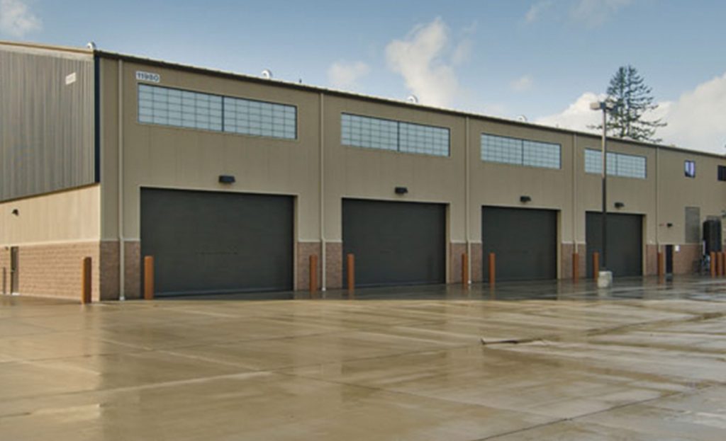 A large distribution center in the Lakewood and JBLM industrial corridor, representing the scale of logistics and military-adjacent site protection required in this high-traffic zone.